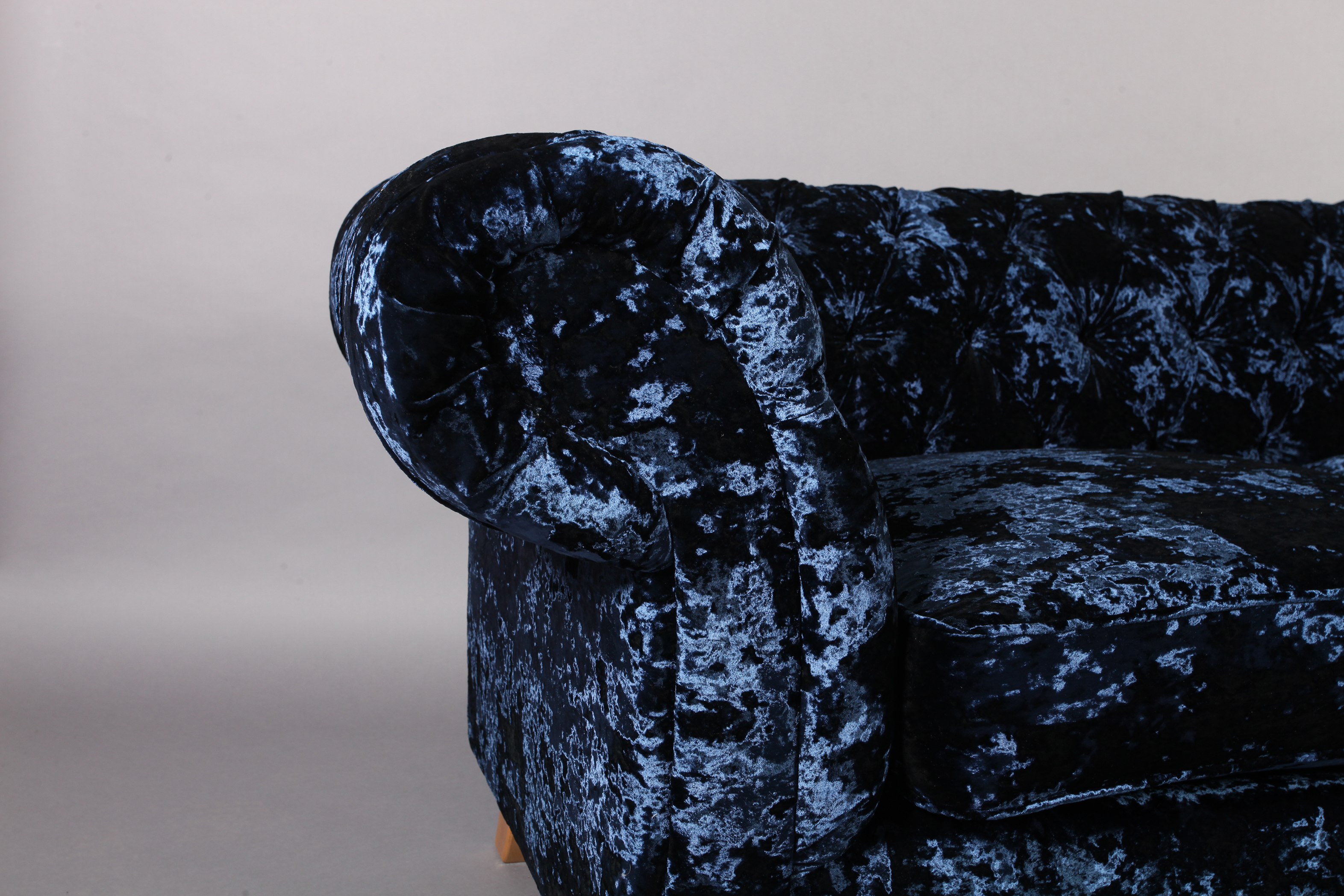 A three seater sofa upholstered in royal blue crushed velvet, on turned legs with chrome castors, - Image 2 of 4