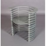 An interesting silver painted tub chair of flattened C-shaped stacked segments supported on five