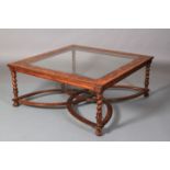 A reproduction oyster veneered coffee table with inset glass surface, crossgrained border, on barley