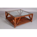 A hardwood and glass inset coffee table, square, with railed undertier, on stile feet, 100cm