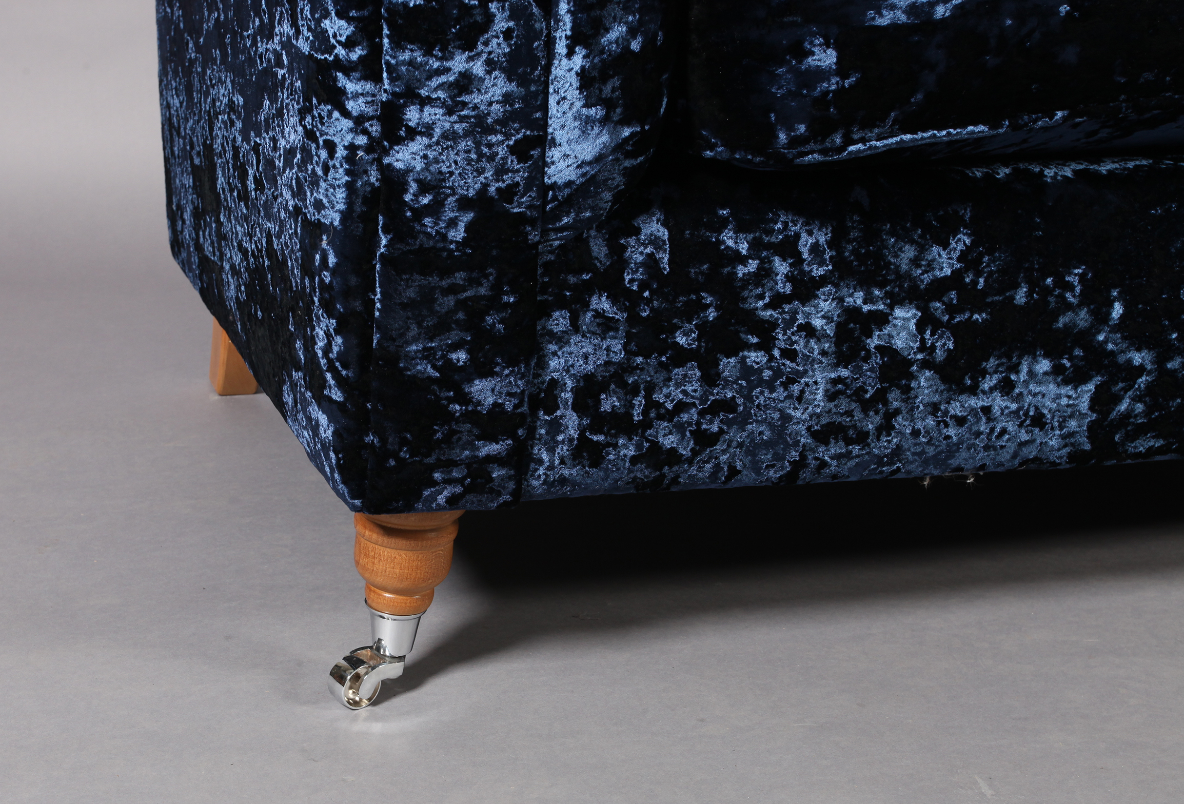 A three seater sofa upholstered in royal blue crushed velvet, on turned legs with chrome castors, - Image 3 of 4