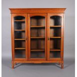 A Victorian oak triple book case top with arched glazed doors on turned legs, flared cavetto