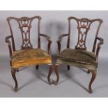 A pair of reproduction mahogany elbow chairs in George III style with pierced shell and foliate