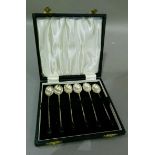A set of six silver bean handled coffee spoons in fitted case