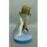 A Copenhagen model of a young girl bather amidst waves, model 1229, 12cm high, printed mark in green