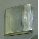 A George V silver cigarette case of square form with engine turned and reeded bands, the front