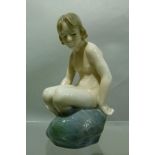 A Copenhagen porcelain model of a naked youth seated on a rock, 14.5cm high, printed mark in