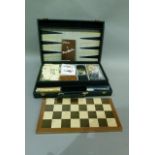 A games compendium comprising backgammon board, checkers board, dominos, cards, cribbage, dice and