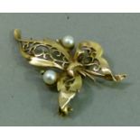 A cultured pearl leaf brooch in 9ct gold, the two 4.5mm pearls flanking and within the pierced