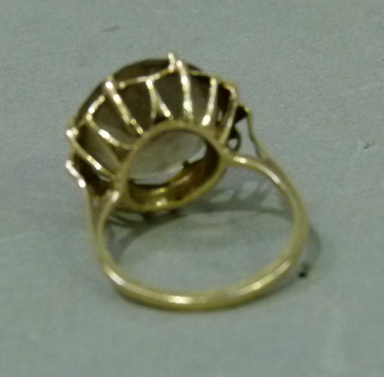 A smoky quartz dress ring in 9ct gold, the circular faceted stone claw set, raised against a star - Image 4 of 5