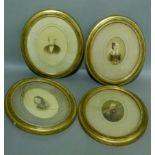 A set of four Edwardian gilt framed photographs, head and shoulder portraits within guilloche and