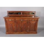 A Victorian oak sideboard with shallow bevelled mirror upstand the base fitted one long and two