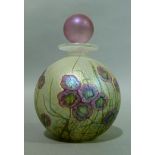 An Isle of Wight spherical glass scent bottle of mauve, green and gilt iridescent floral design with