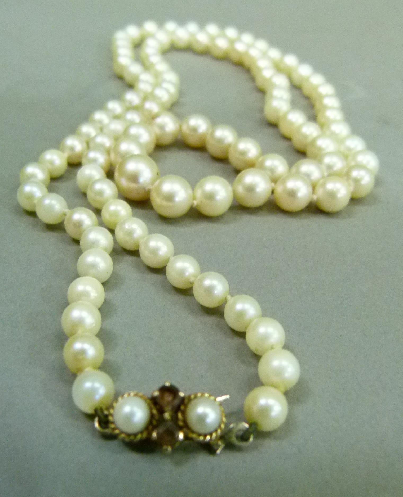 A cultured pearl necklace, the graduated pearls fastened with a 9ct gold pearl and amethyst set - Image 2 of 2