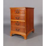 A reproduction yew veneered filing cabinet, the rectangular top inset with a gilt tooled green