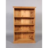 A reproduction pine open bookcase, 76cm x 122cm