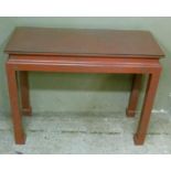 A Chinese style console table painted in grey and red marble effect with glass top, 91cm wide x 36cm