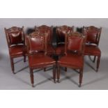 A set of six late Victorian walnut dining chairs, the shaped top rails carved to the centre with urn