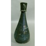 An interesting Persian 19th century flask shaped vase, the body inlaid in white metal with leafy