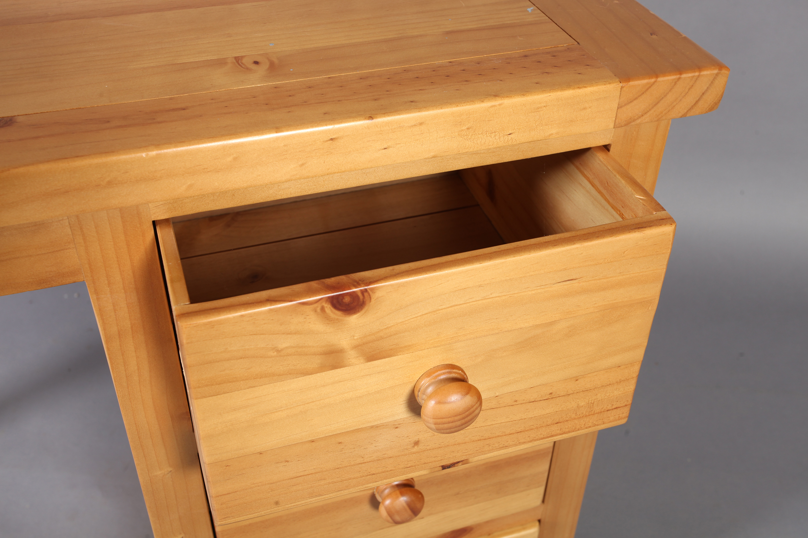 A reproduction pine single pedestal desk with kneehole flanked by three short drawers, rectangular - Image 2 of 2