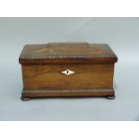 A William IV rosewood veneered sarcophagus shaped tea caddy with bead and reel borders throughout,