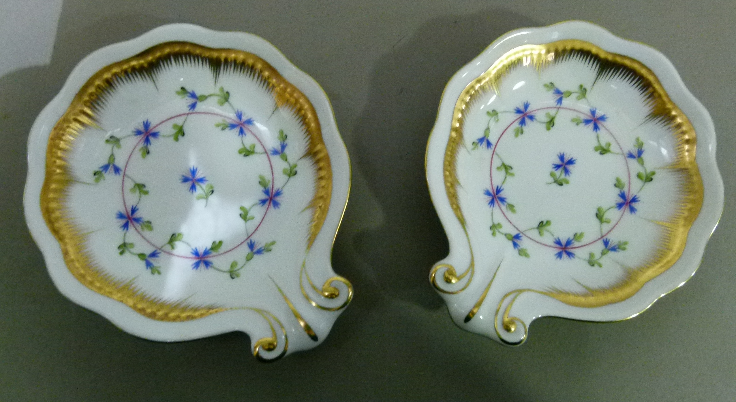 A pair of Herend shell shaped dished painted to the centres with Angouleme sprigs within a gilt