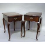 A pair of reproduction mahogany single drawer tables of serpentine square form with figured tops, on