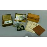 A quantity of British and foreign coins, a pound note, a burr wood box and a brass cigarette box