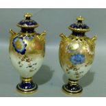 A pair of Royal Crown Derby two handled vases and covers, the egg shaped bodies decorated with