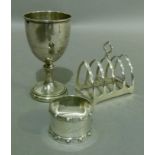 A silver five bar toast rack, Sheffield 1963, a napkin ring engraved Lorraine, Birmingham 1945, a