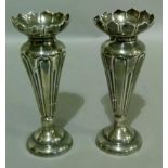 A pair of Edward VII spill vases with lappet frilled tops, the tapered panelled bodies on