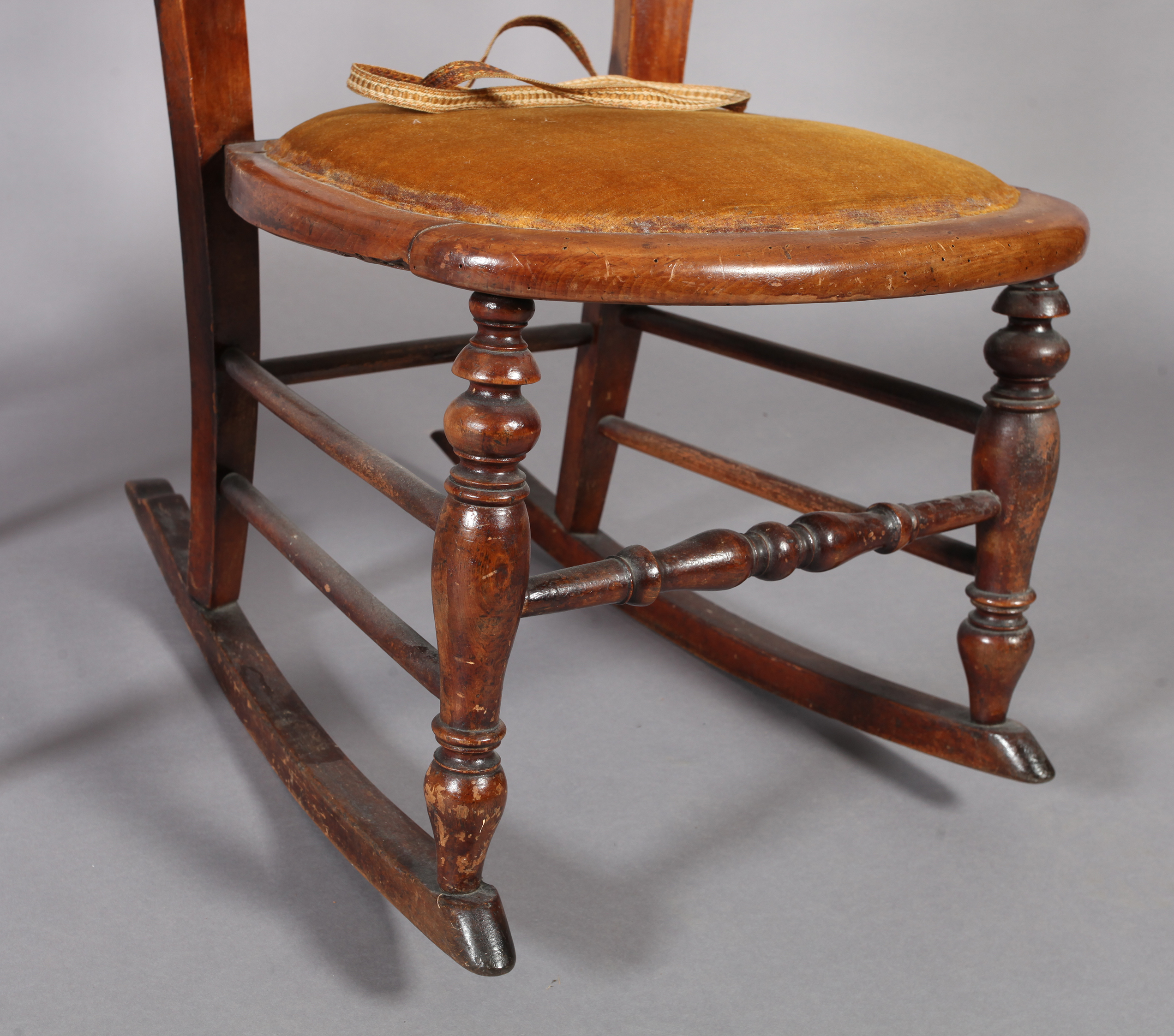 A Victorian walnut framed rocking chair, the back with caned panel above a velvet seat, turned - Image 4 of 4