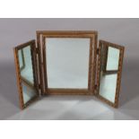 A gold painted triptych dressing table mirror with ribbon carved frame, 58cm high