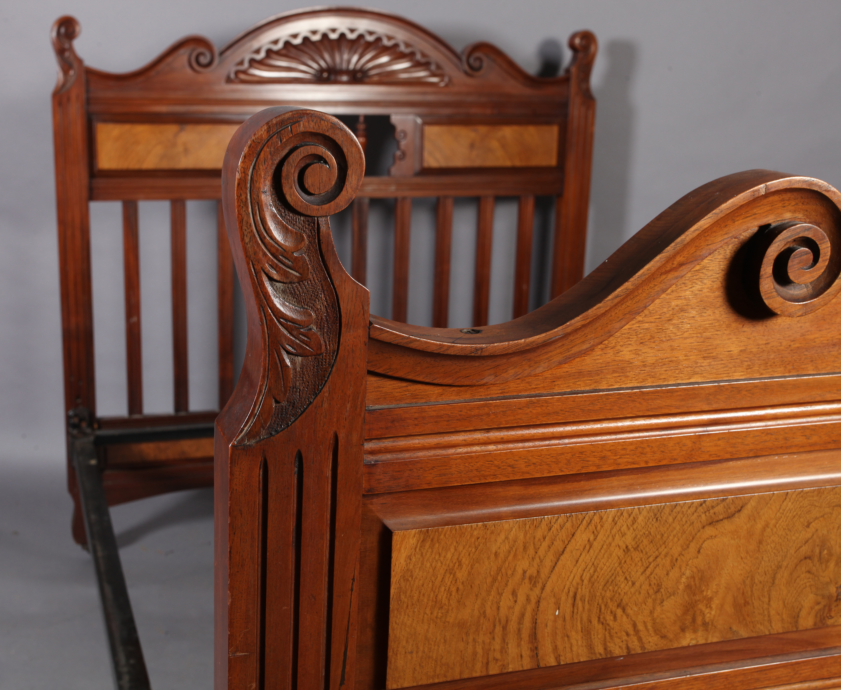 A Victorian walnut double bedstead with figured panels and railed headboard together with an