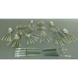 A suite of King's pattern EPNS cutlery comprising nine table knives and forks, six dessert spoons,