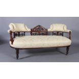 A Victorian walnut salon sofa with central pierced and carved rail flanked by upholstered panels