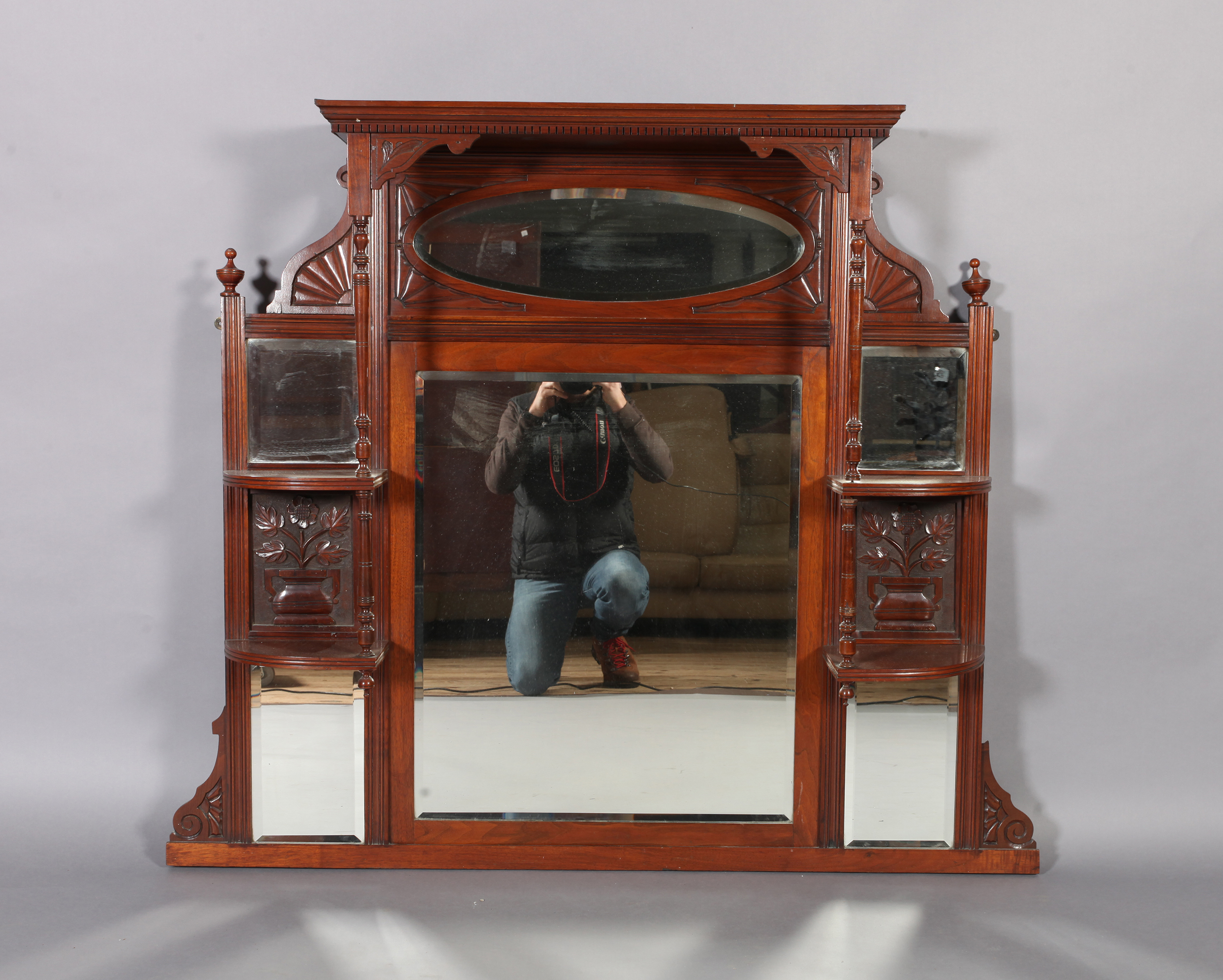 A Victorian mirror back overmantel with dental moulded cornice shelves and pillars, carved panels