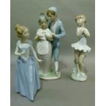 Three Nao figures including a figure group of a young man and girl with dove, girl with fan and girl