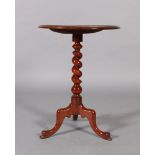 A Victorian mahogany tripod table the circular table above a barley turned column, three outwept
