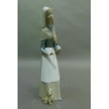 A Lladro shepherdess with dog, code 1034, year 1969 28cm high