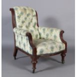 A Victorian mahogany framed elbow chair with upholstered scroll over back and arms, the bowed feet