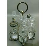 A late Victorian six bottle breakfast cruet on a silver plated stand with looped carrying handle,