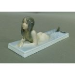 A Copenhagen porcelain model of a mermaid on a rectangular base, model 1212, 19.5cm wide, printed