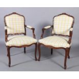 A pair of reproduction elbow chairs in Louis XVI style, the foliate carved and scroll moulded