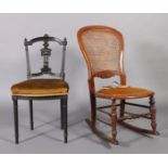 A Victorian walnut framed rocking chair, the back with caned panel above a velvet seat, turned