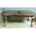 A mahogany extending table, wind out mechanism, cabriole legs on claw and ball feet with later