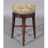 A post Regency mahogany revolving circular music stool, the stuffed over top with reeded rim, four