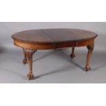 A reproduction extending dining table in George III style, the oval top with gadroon lip above a