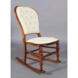 A Victorian walnut stained beech rocking chair, the rounded back with buttoned upholstered panel,