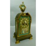 A 19th century French brass mounted porcelain clock with urn finial, the broken pediment above a